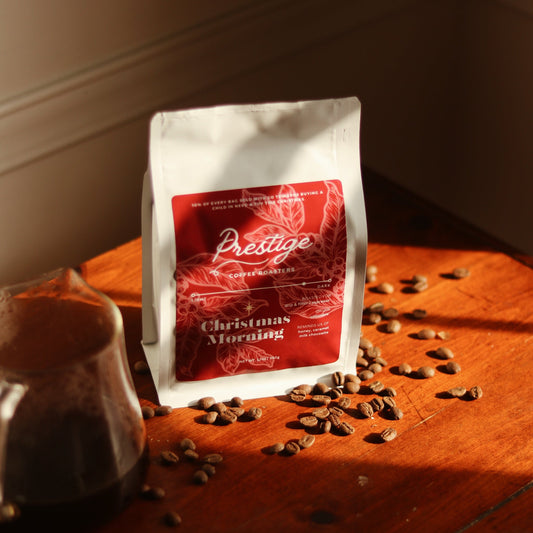 Prestige coffee bag with coffee beans on a wooden surface